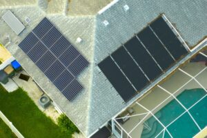 Standard american residential house with rooftop covered with solar photovoltaic panels for producing of clean ecological electrical energy in suburban rural area. Concept of autonomous home.